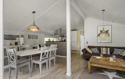 a dining room and living room with a table and chairs at 3 Bedroom Nice Home In Fjerritslev in Fjerritslev