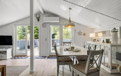 a dining room and kitchen with a table and chairs at 3 Bedroom Nice Home In Fjerritslev in Fjerritslev