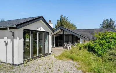 a house with sliding glass doors on the side of it at Amazing Home In Thisted With Sauna in Thisted