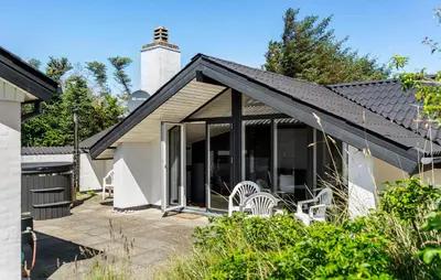 a home with a large patio with white chairs at Amazing Home In Thisted With Sauna in Thisted