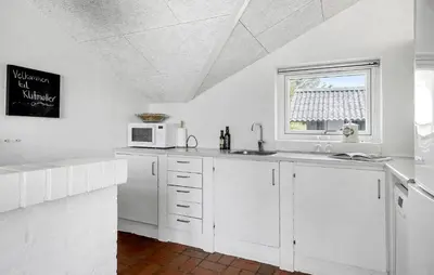 a white kitchen with a sink and a window at Amazing Home In Thisted With Sauna in Thisted