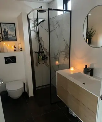 a bathroom with a shower and a toilet and a sink at Villa Centrum in Holstebro