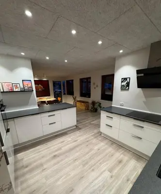 a large room with white cabinets and wooden floors at Villa Centrum in Holstebro