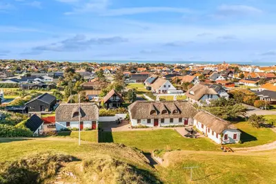 an aerial view of a village with houses at 3008Møllehuset Baghusetanneks in Blokhus