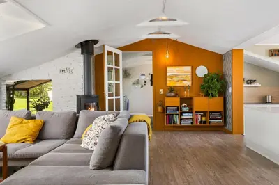 a living room with a couch and a kitchen at Granlien 3, A Holiday Home With Soul And Charm! in Blokhus