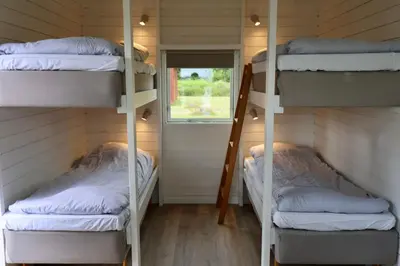 two bunk beds in a room with a window at Aalborg Hytteø in Aalborg