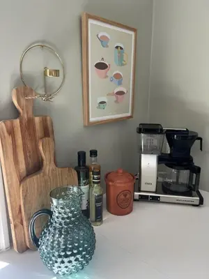 a kitchen counter with a vase on a table at VillaRanum in Ranum