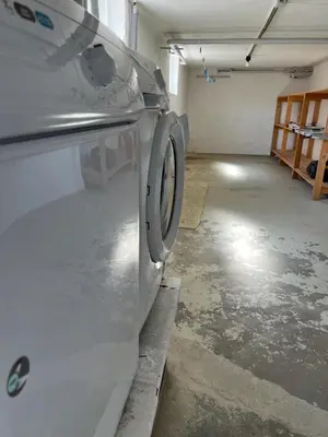a washing machine sitting in a garage with a room at VillaRanum in Ranum