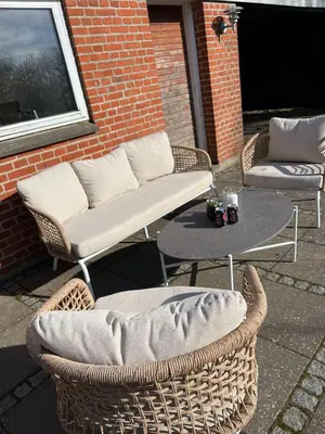 a patio with two chairs and a table and a couch at VillaRanum in Ranum