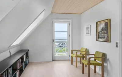 a dining room with a table and chairs and a window at Amazing Home In Spøttrup in Spottrup