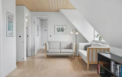 a living room with a couch and a chair at Amazing Home In Spøttrup in Spottrup