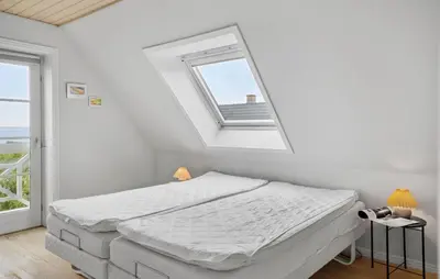 a white bedroom with a bed and a window at Amazing Home In Spøttrup in Spottrup