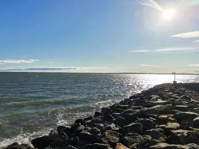 a large body of water with a rocky shoreline at 6 person holiday home in Thyholm in Thyholm