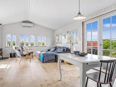 a living room with a couch and a table at Holiday Home Thine - 250m from the sea by Interhome in Harboør