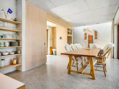 a dining room with a wooden table and chairs at Holiday Home Rieke - 250m from the sea by Interhome in Torsted