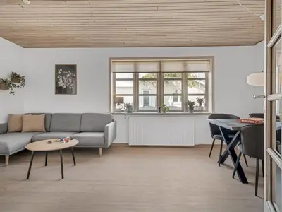 a living room with a couch and a table at Holiday Home Antine - 400m from the sea by Interhome in Thyborøn