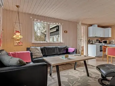 a living room with a couch and a table at Holiday Home Iris - 200m to the fjord by Interhome in Thyholm