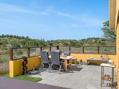 a patio with a table and chairs on a balcony at Holiday Home Ola - 900m from the sea by Interhome in Bedsted Thy