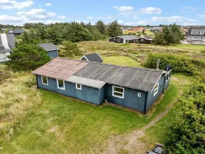 an overhead view of a blue house in a field at Holiday Home Claudine - 700m from the sea by Interhome in Thisted