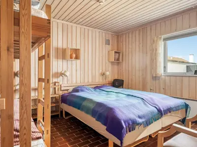 a bedroom with a bunk bed and a window at Holiday Home Aike - 1km from the sea by Interhome in Pandrup