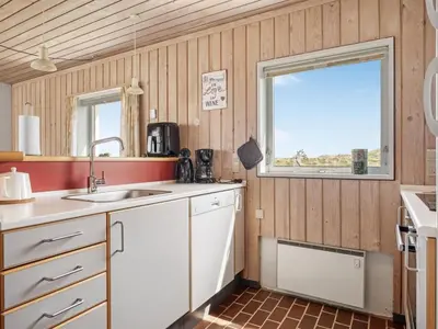 a kitchen with a sink and a window at Holiday Home Aike - 1km from the sea by Interhome in Pandrup