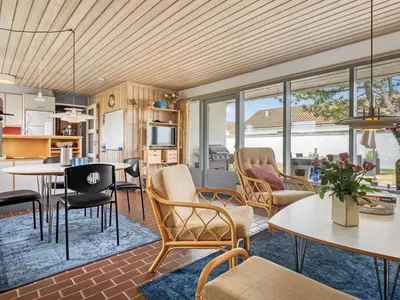 an open living room with tables and chairs at Holiday Home Aike - 1km from the sea by Interhome in Pandrup
