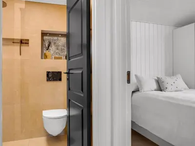 a bathroom with a bed and a toilet in a room at Holiday Home Marcus - 500m from the sea by Interhome in Saltum