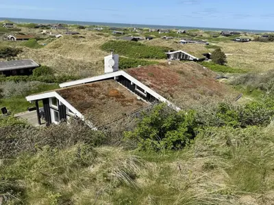 an old house on top of a grassy hill at Holiday Home Marcus - 500m from the sea by Interhome in Saltum