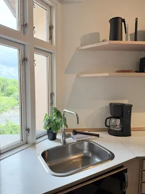 a kitchen with a sink and a window at Cozy pearl downtown Viborg in Viborg