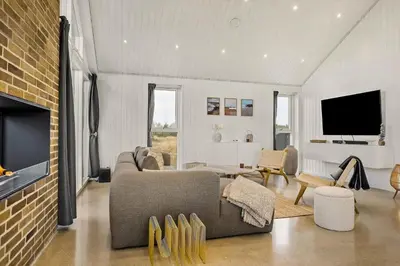 a living room with a couch and a tv at 1314-Thisted-Lyngbakken-14 in Thisted