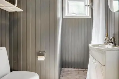 a bathroom with a toilet and a sink at 1067-Thisted-Gra-Rimme-7 in Torsted