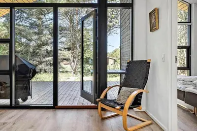 a rocking chair in a room with sliding glass doors at 1323-Thisted-Fiskervej-96 in Thisted