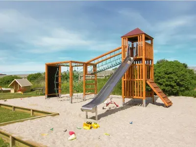 a playground with a slide in the sand at 4 star holiday home in Thyborøn in Thyborøn