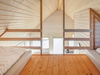 a bedroom with a bed and a wooden floor at 4 star holiday home in Thyborøn in Thyborøn