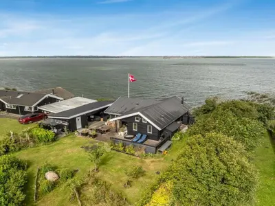 an aerial view of a house on the water at Holiday Home Diderik - 20m to the fjord by Interhome in Roslev