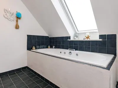 a bath tub in a bathroom with a window at 6 person holiday home in Vestervig in Vestervig