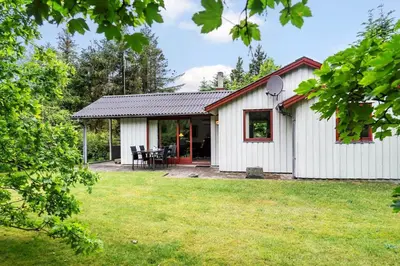a white cottage with a patio and grass at 724-Vestervig-Kanalvej-24 in Tåbel