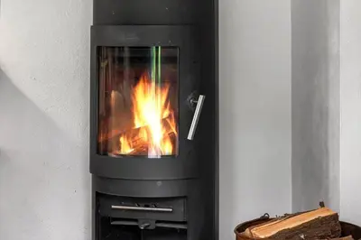 a stove with a fire in it in a room at 724-Vestervig-Kanalvej-24 in Tåbel