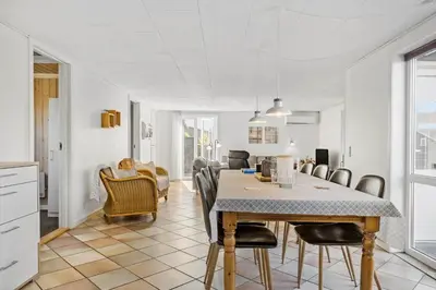 a kitchen and dining room with a table and chairs at 1046-Thisted-Johns-Vej-26 in Torsted