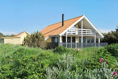 a house on top of a hill with flowers at 644-Thisted-Kristinesvej-4 in Thisted