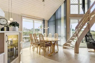 a dining room with a table and chairs and a staircase at 644-Thisted-Kristinesvej-4 in Thisted