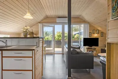 a kitchen and living room with a couch and a tv at 528-Thisted-Tunvej-28 in Thisted