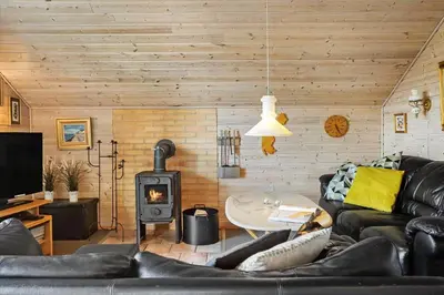 a living room with a couch and a wood stove at 528-Thisted-Tunvej-28 in Thisted