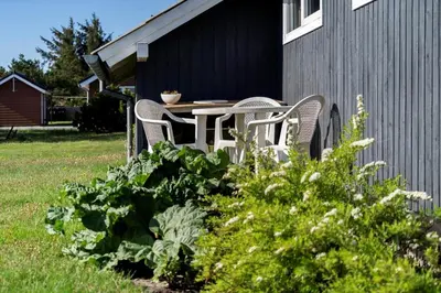 two chairs and a table on the side of a house at 323-Thisted-Pighvarvej-27 in Thisted
