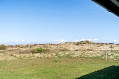 a field of grass with a hill in the background at 323-Thisted-Pighvarvej-27 in Thisted