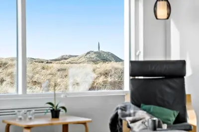 a room with a chair and a table and a window at 106-Thisted-Simonsvej-6 in Thisted