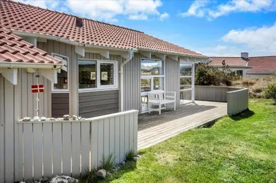 a house with a wooden deck in a yard at 1026-Thisted-Niels-Vognmands-Vej-26 in Torsted