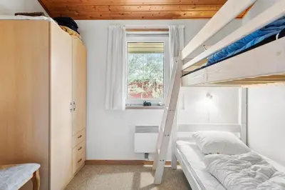 a bedroom with two bunk beds and a window at 560-Thisted-Klitrosevej-60 in Thisted
