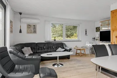 a living room with a leather couch and a table at 780-Thisted-Molgaardsvej-60 in Thisted