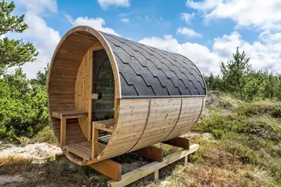 a circular wooden hobbit house with a black roof at 780-Thisted-Molgaardsvej-60 in Thisted